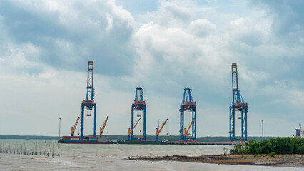 PHU MY, BA RIA - VUNG TAU, VIETNAM - SEP 07, 2024: Giant cranes are working at Cai Mep...