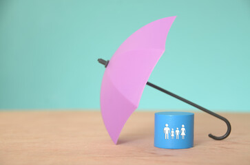 The umbrella represents the coverage provided by insurance policies, shielding people from...
