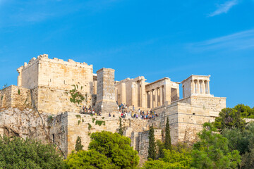 Fototapeta premium Tourists entering the Acropolis of Athens, Greece in the summer