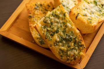 Delicious Garlic Bread with Parmesan Close-Up on Dark Background