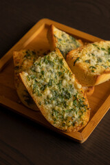 Delicious Garlic Bread with Parmesan Close-Up on Dark Background