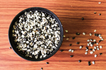 Split Black Lentil Also Know as Black Gram, Black Urad Dal, Vigna Mungo, Urad Bean on brown wooden Background
