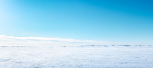 Obraz premium A serene, snowy landscape with a clear sky and space for text 