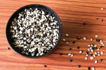 Split Black Lentil Also Know as Black Gram, Black Urad Dal, Vigna Mungo, Urad Bean on brown wooden...