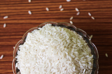White rice bowl in wood isolated, Concept of Water-Conserving Products. Saving water. Horizontal orientation. Raw basmati rice on  wooden
