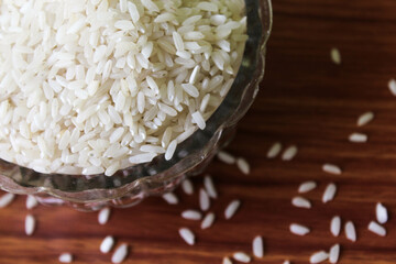 White rice bowl in wood isolated, Concept of Water-Conserving Products. Saving water. Horizontal orientation. Raw basmati rice on  wooden

