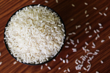 White rice bowl in wood isolated, Concept of Water-Conserving Products. Saving water. Horizontal orientation. Raw basmati rice on  wooden
