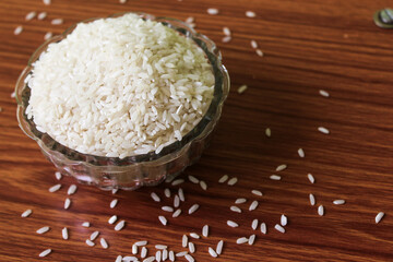 White rice bowl in wood isolated, Concept of Water-Conserving Products. Saving water. Horizontal orientation. Raw basmati rice on  wooden
