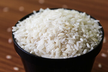 White rice bowl in wood isolated, Concept of Water-Conserving Products. Saving water. Horizontal orientation.Raw basmati rice on  wooden

