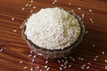 White rice bowl in wood isolated, Concept of Water-Conserving Products. Saving water. Horizontal orientation. Raw basmati rice on  wooden
