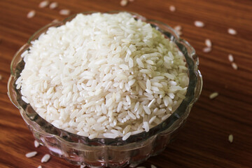 White rice bowl in wood isolated, Concept of Water-Conserving Products. Saving water. Horizontal orientation. Raw basmati rice on  wooden
