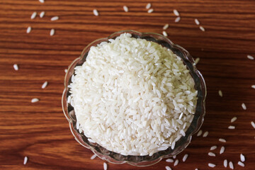 White rice bowl in wood isolated, Concept of Water-Conserving Products. Saving water. Horizontal orientation. Raw basmati rice on  wooden
