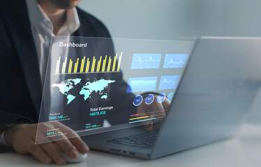 Businessman using computer dashboard analyzing sales data and financial report. Financial Management data System KPI connected in database for follow earnings,operations and sales data.