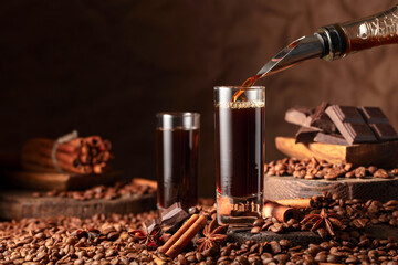 Coffee liquor is poured from a bottle into a glass.
