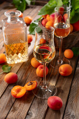 Apricot liqueur or grappa and fresh apricots.
