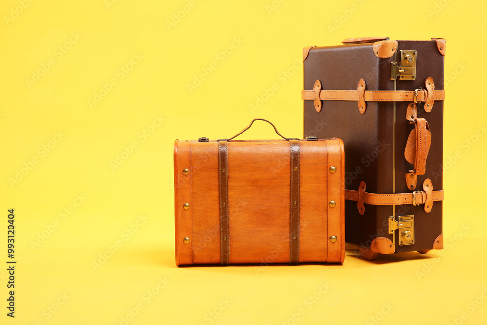 Sticker Two different brown suitcases on yellow background, space for text