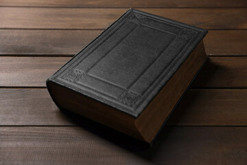 Closed Bible on wooden table. Christian faith