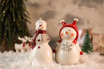 Funny snowmen figures on artificial snow, closeup