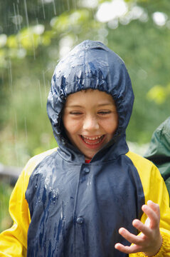 Smiling Young Boy in the Rain
