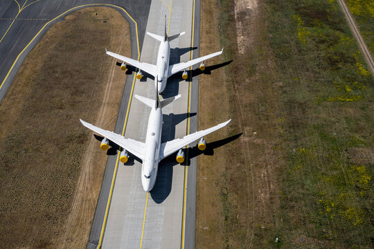 High angle view airplanes on sunny airport runway
