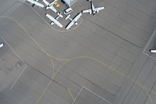 View from above propellor airplanes and lines on airport tarmac
