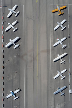 View from above biplanes parked in rows on airport tarmac
