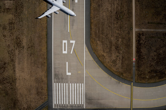 View from above airplane parked on airport runway
