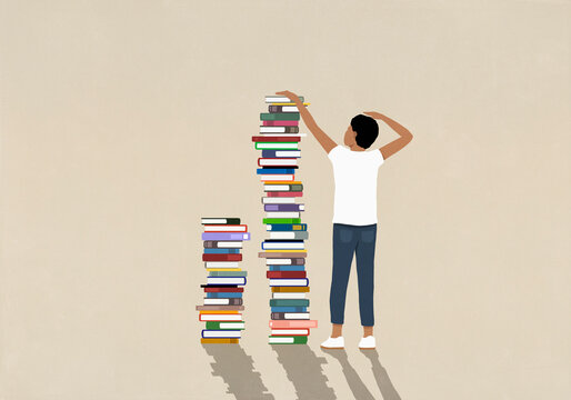 Man measuring height next to tall stack of books
