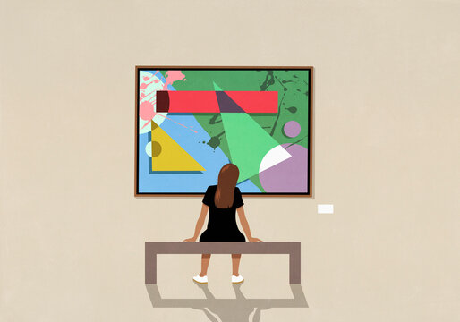 Woman leaning and viewing abstract painting in museum
