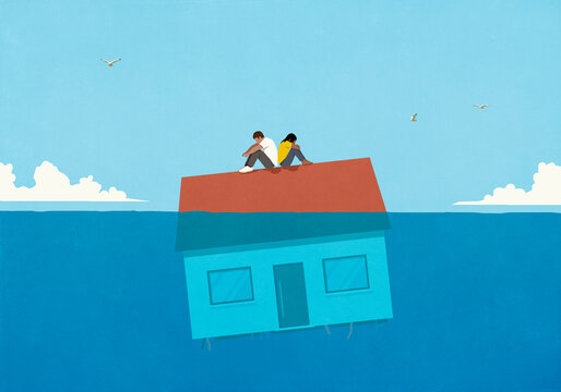 Defeated couple sitting back to back on house sinking in water
