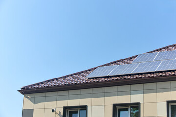 Solar panels on roof with copyspace. Building with lots of solar panels. Renewable solar energy. Alternative Generator Energy efficient house uses solar energy of sun.