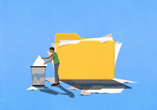 Man placing torn files from messy folder into garbage can
