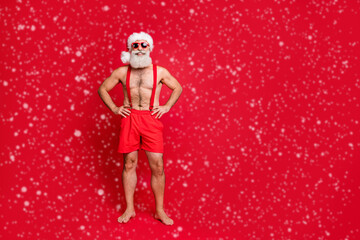 Full length body size view of his he nice attractive content cheerful cheery funky gray-haired man hands on hips holly jolly travel resort isolated over bright vivid shine red background