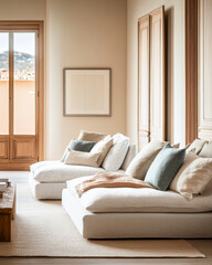 Fototapeta premium Cozy living room with light-colored couches and soft pillows, featuring large windows overlooking a serene outdoor view in the afternoon light