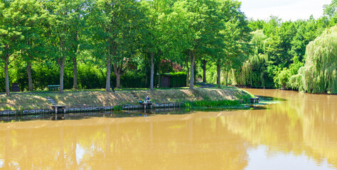 Fishing at the Kasteelgracht, Ypres, Belgium. The east bank of the moat surrounding the town of Ieper.