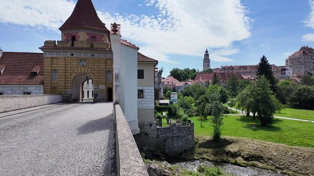 View from Budweiser Gate in Česk&yacute; Krumlov overlooking lush greenery and historic buildings