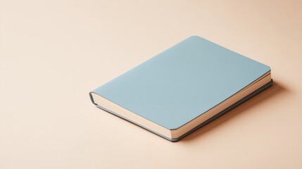 A simple blue notebook resting on a beige surface, ready for writing or sketching ideas in a calm setting.