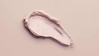 Bb cream smear cosmetic product over beige background. Make up base skin care, foundation, concealer smudge close up. Skin corrector, beauty facial treatment stroke closeup. Top view