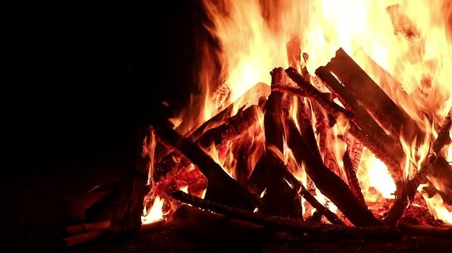 View loop of burning firewoods, bright firecamp with sparks at night, Camp fire in the night. Exploring the wildness travelling in outdoor