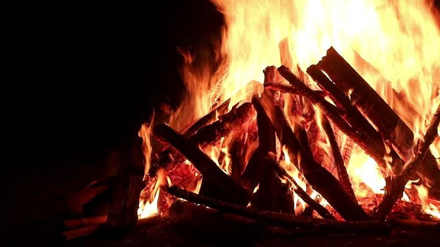 View loop of burning firewoods, bright firecamp with sparks at night, Camp fire in the night. Exploring the wildness travelling in outdoor