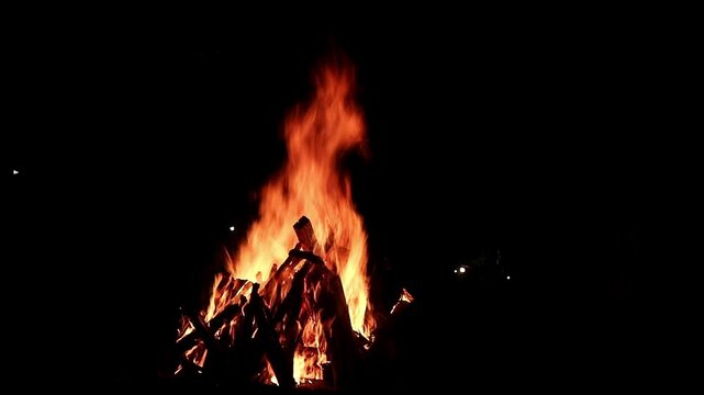 View loop of burning firewoods, bright firecamp with sparks at night, Camp fire in the night. Exploring the wildness travelling in outdoor