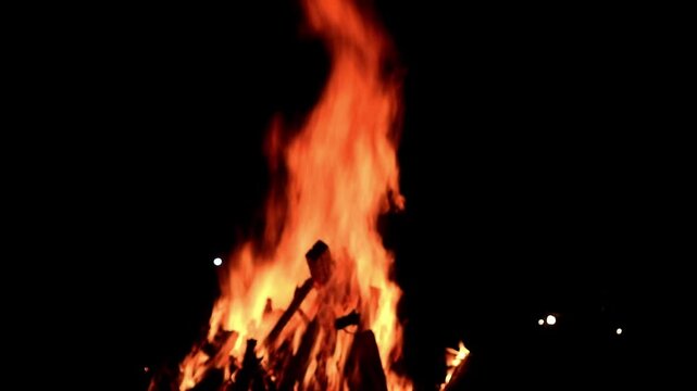View loop of burning firewoods, bright firecamp with sparks at night, Camp fire in the night. Exploring the wildness travelling in outdoor