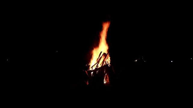 View loop of burning firewoods, bright firecamp with sparks at night, Camp fire in the night. Exploring the wildness travelling in outdoor