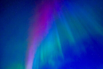 Northern lights dancing over dark specwe in the night. Scenic view of a space area landscape with northern lights in Sweden