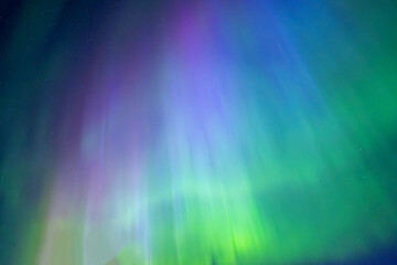 Northern lights dancing over dark specwe in the night. Scenic view of a space area landscape with northern lights in Sweden