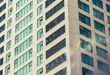 People are drawing attention to themselves and calling for help from the windows of a burning multi-story building. Rescue operation training is underway