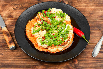 Cauliflower steaks with herb and sauce.