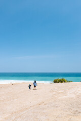 Mother and son walking to the edge of the cliff