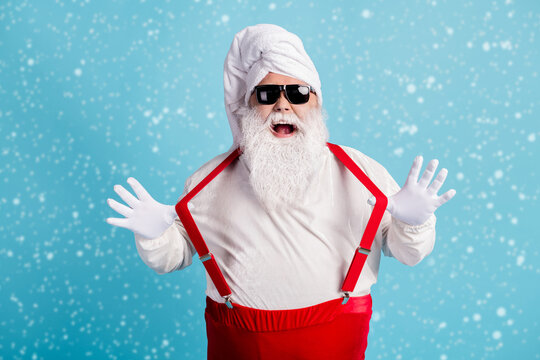 Enjoy your bath. Photo of retired old man grey beard hold playing strap open mouth took shower feel young wear santa costume towel turban suspender sunglass isolated blue color background