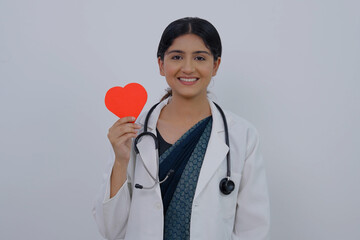 Indian Female Doctor Holding Heart and Smiling at Camera